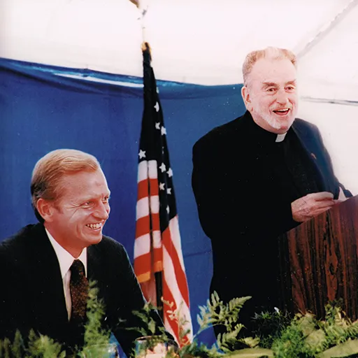Brennan’s father says grace at the Bush luncheon.